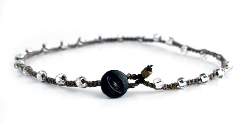 Created with crystal Czech glass. Each includes a carved vintage light, or dark, mother of pearl button clasp closure. Brown cord.