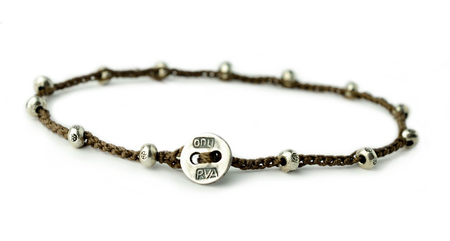 Created with Thai sterling silver.  Finished with an authentic sterling silver on u button.  Brown cord.