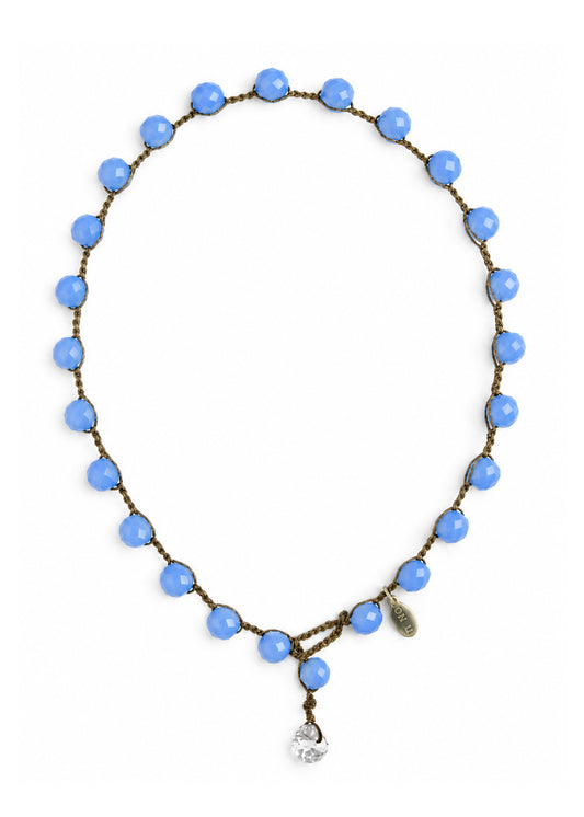 A beaded necklace with cornflower blue faceted beads hand-crocheted onto a brown cord, featuring an authentic "on u" tag and a clear crystal pendant.  Designed and created by On U Jewelry, Richmond, Virginia.