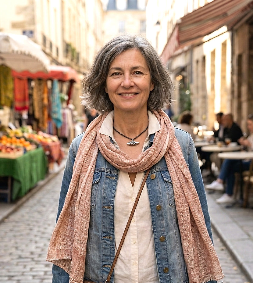 Detail view of a vintage Navajo silver fluted shell button pendant on a hand-crocheted cord with sterling silver beads by On U Jewelry.