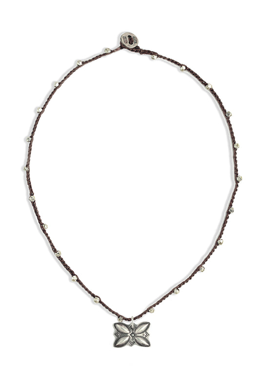 A bohemian-style necklace featuring a brown hand-crocheted cord adorned with small silver beads, and a sterling silver vintage Navajo Silver butterfly button by On U Jewelry, Richmond, VA.